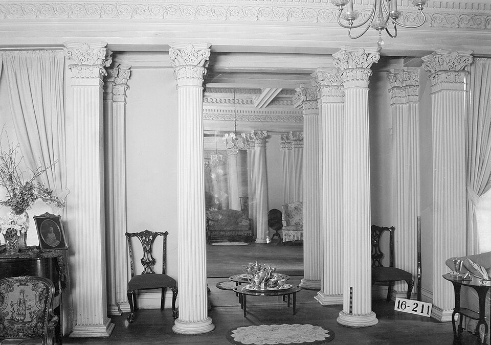 Black-and-white historic photo of the ballroom at Gaineswood, with rows of fluted columns