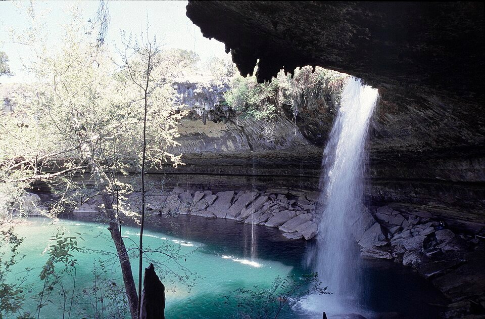 View from inside the grotto toward the waterfall and the green pool