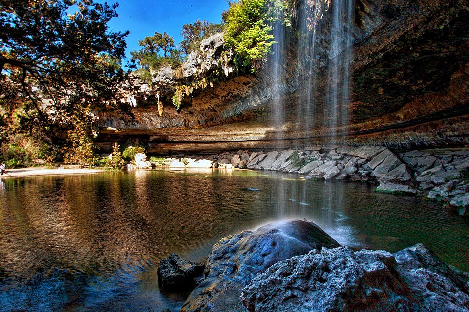 Hamilton Pool, a green pool under a limestone overhang with a waterfall, near Austin