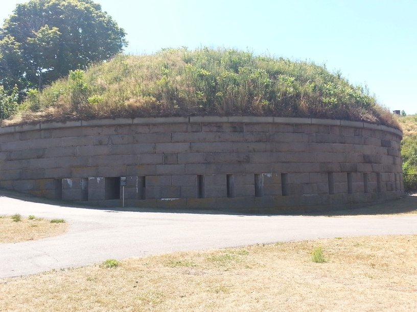 The demilune battery at Fort Warren, a round granite bastion with a grassy top