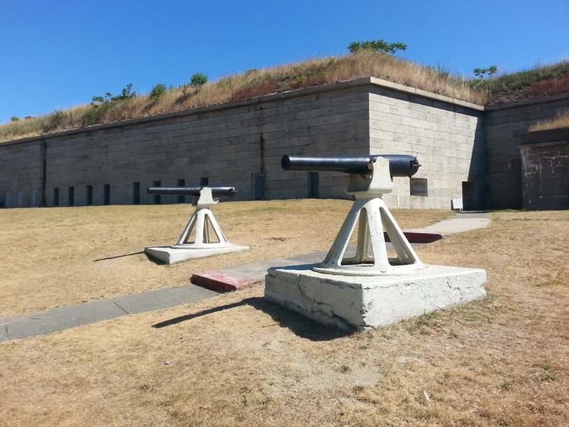 Two 3-inch rifled guns on carriages in front of a Fort Warren wall