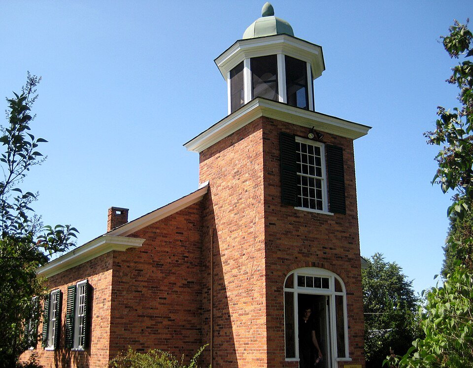 Vergennes schoolhouse, a brick building with a white cupola and green shutters