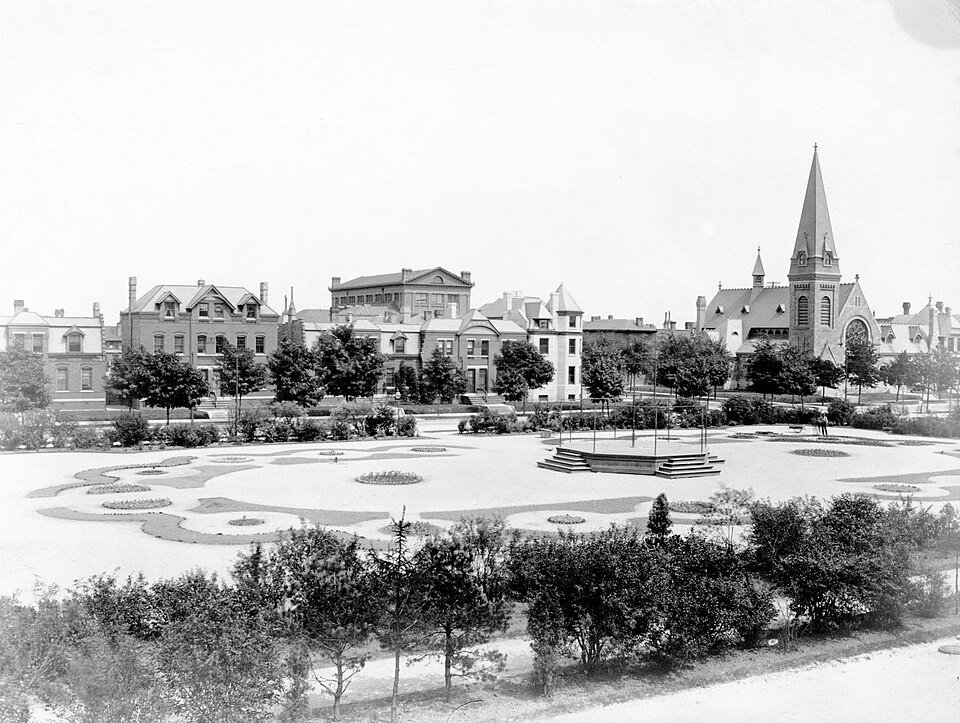 The park at Pullman in a historic photograph, with rowhouses and the spire of the Greenstone church