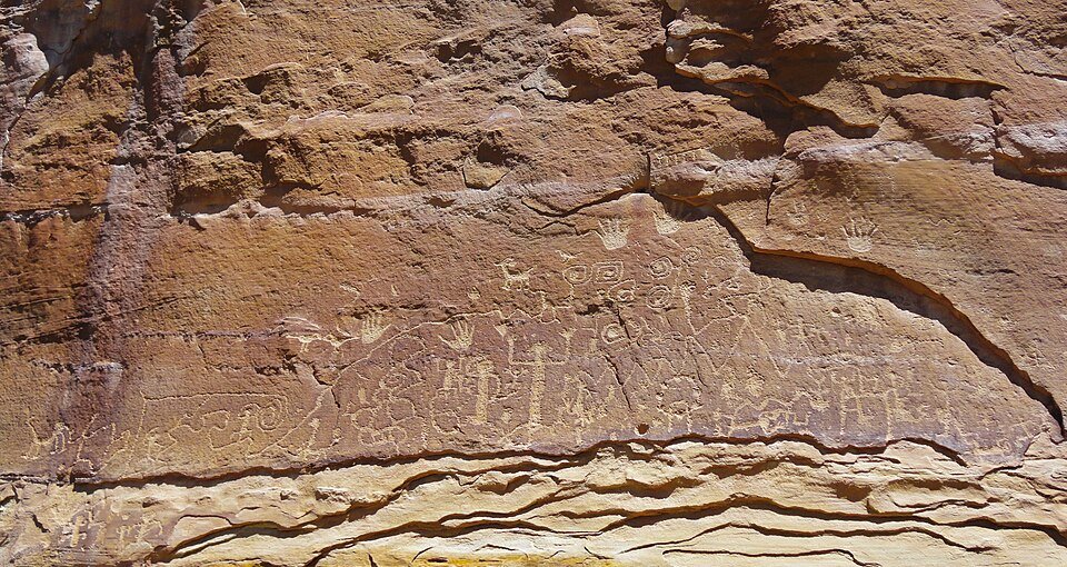 Petroglyph Point: rock carvings, including handprints and small figures, on a sandstone wall