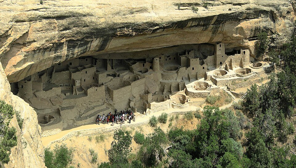 Cliff Palace at Mesa Verde: a village of stone rooms and towers built under a sandstone cliff overhang