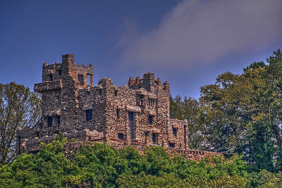Gillette Castle, a fieldstone mansion with towers and battlements on a wooded hilltop