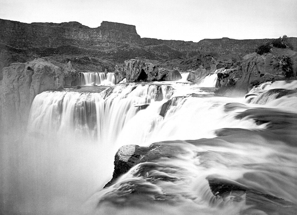 Historic black-and-white photograph of Shoshone Falls on the Snake River, Idaho, with water cascading over rock ledges