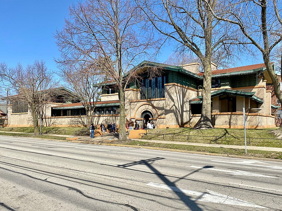 Entrance side of the Dana-Thomas House along Lawrence Avenue, seen through bare trees