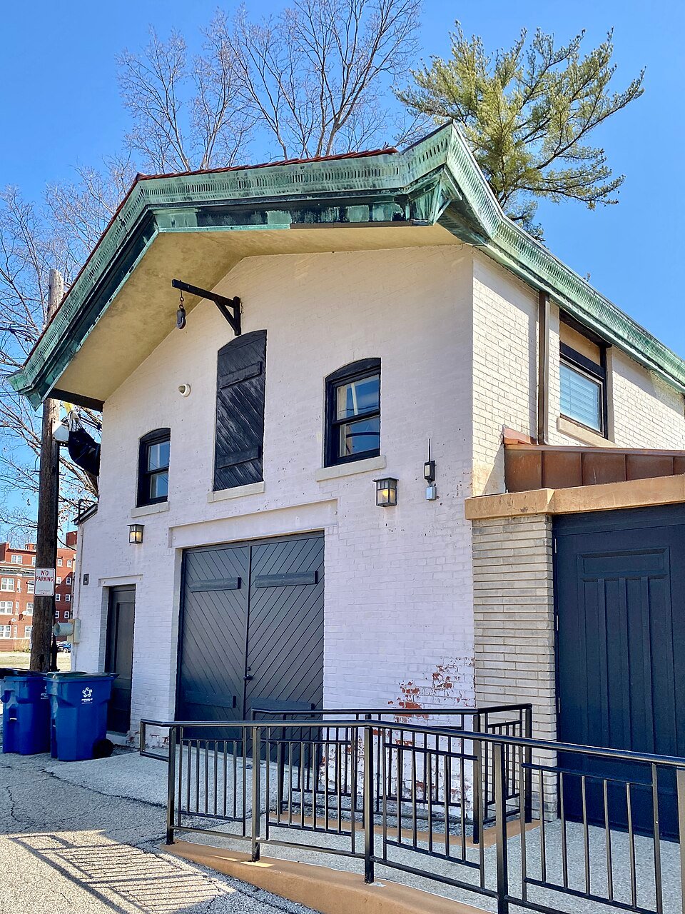 Carriage house of the Dana-Thomas House, a painted brick building with a green copper roof edge
