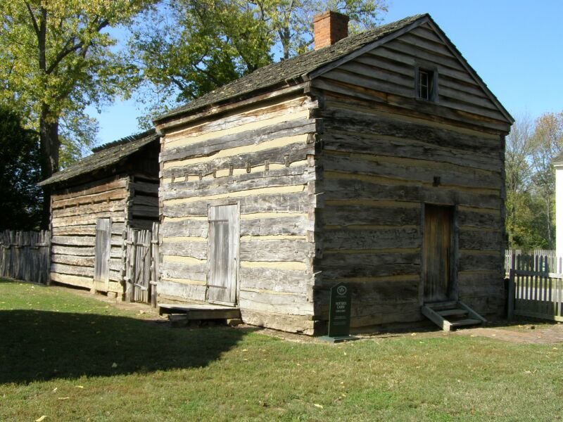 Potter Cabin, a log cabin with a brick chimney and a smaller cabin beside it in New Harmony, Indiana