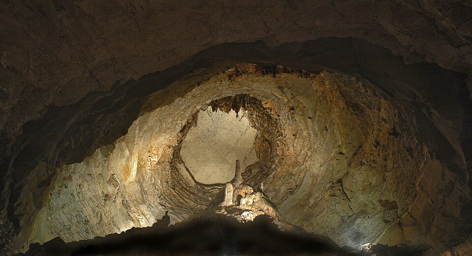 Large domed chamber inside Wyandotte Cave, lit to show its rock walls and a pale formation on the floor