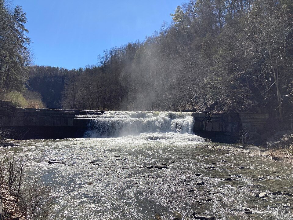 The Lower Falls, a wide low cascade on the creek seen across the water