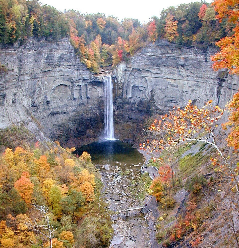Taughannock Falls seen from above in autumn, plunging between tall rock walls into a pool