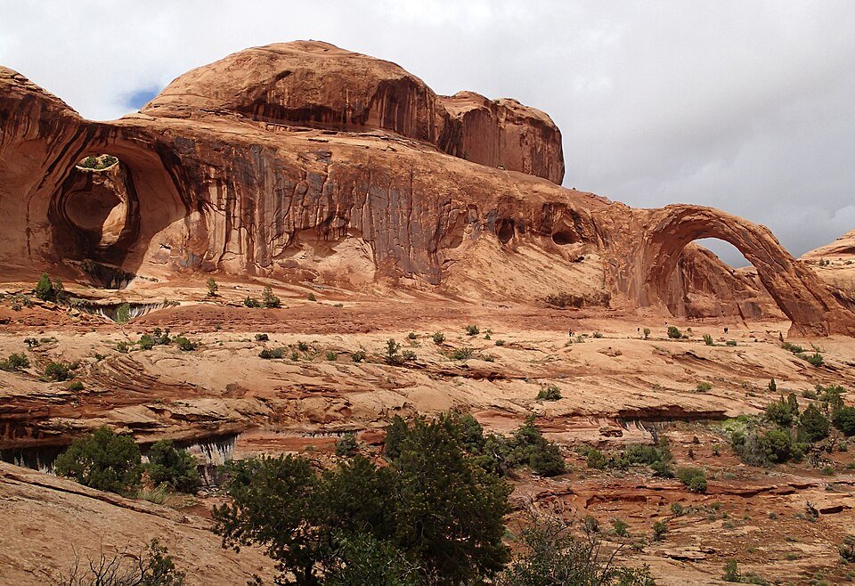 Corona Arch on the right and the Bowtie Arch opening on the left, in the same rock formation