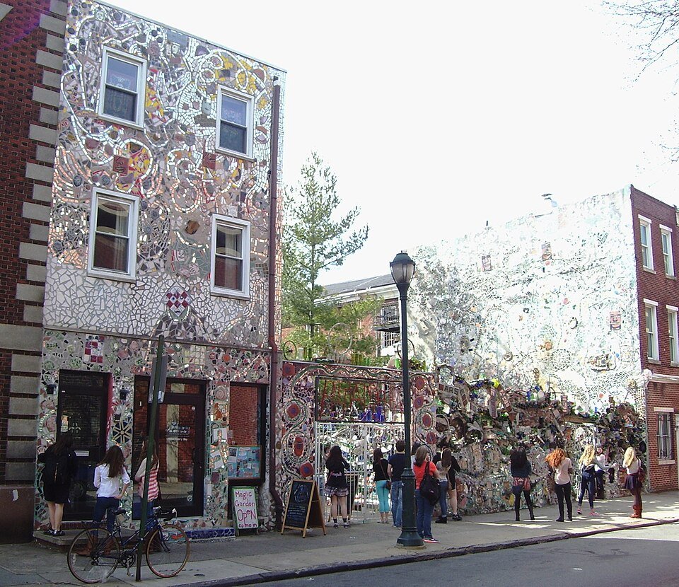 Visitors outside the mosaic-covered buildings of the Magic Gardens on South Street, Philadelphia