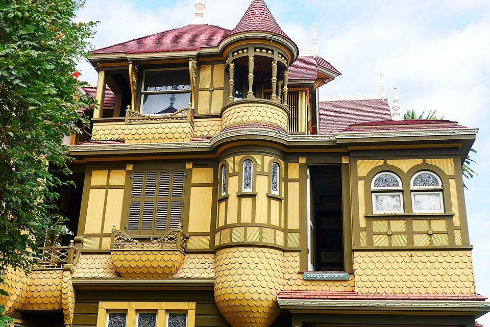 A door to nowhere on an upper floor of the exterior of Winchester Mystery House, marked with a sign