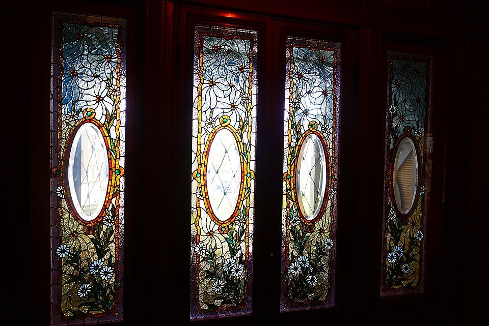 Stained glass windows with a daisy pattern at Winchester Mystery House