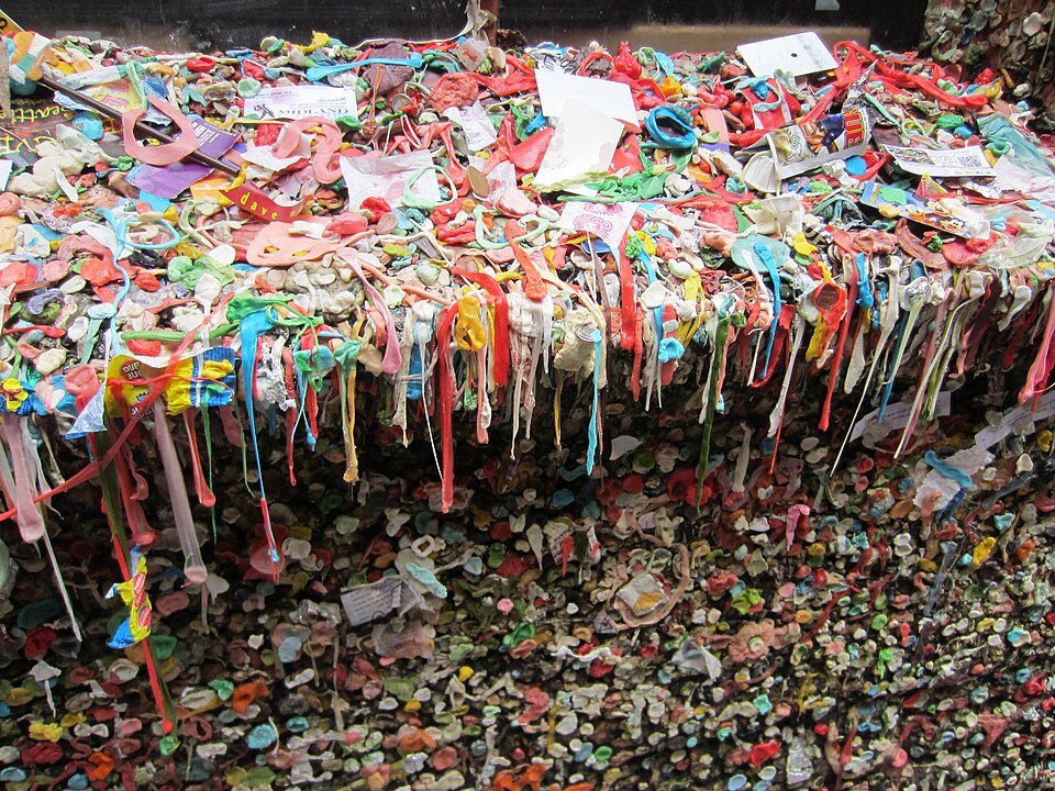 Close-up of chewing gum hanging in colorful strands on the Gum Wall