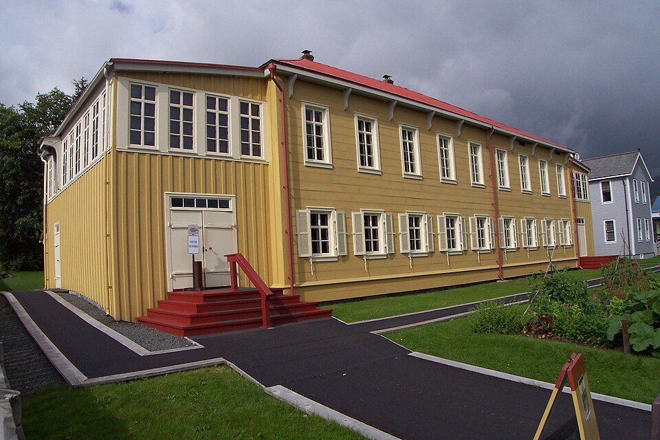 The Russian Bishop’s House seen from the corner, with red entrance steps under a cloudy sky