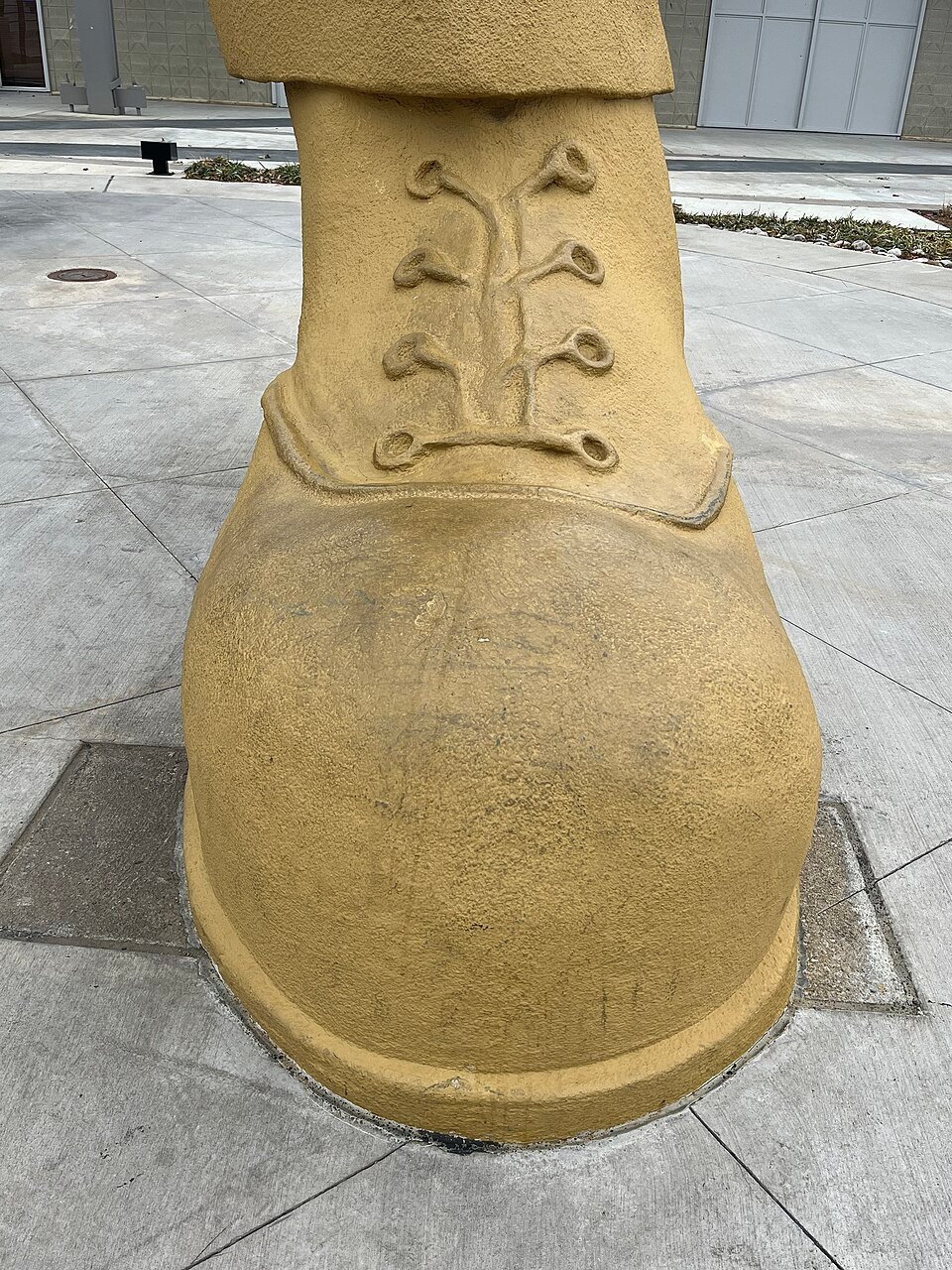 Close view of one of the statue’s boots, with sculpted laces