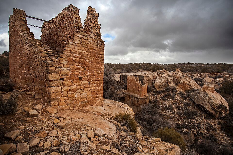 A stone tower and ruins of the Holly group at Hovenweep, beside large boulders