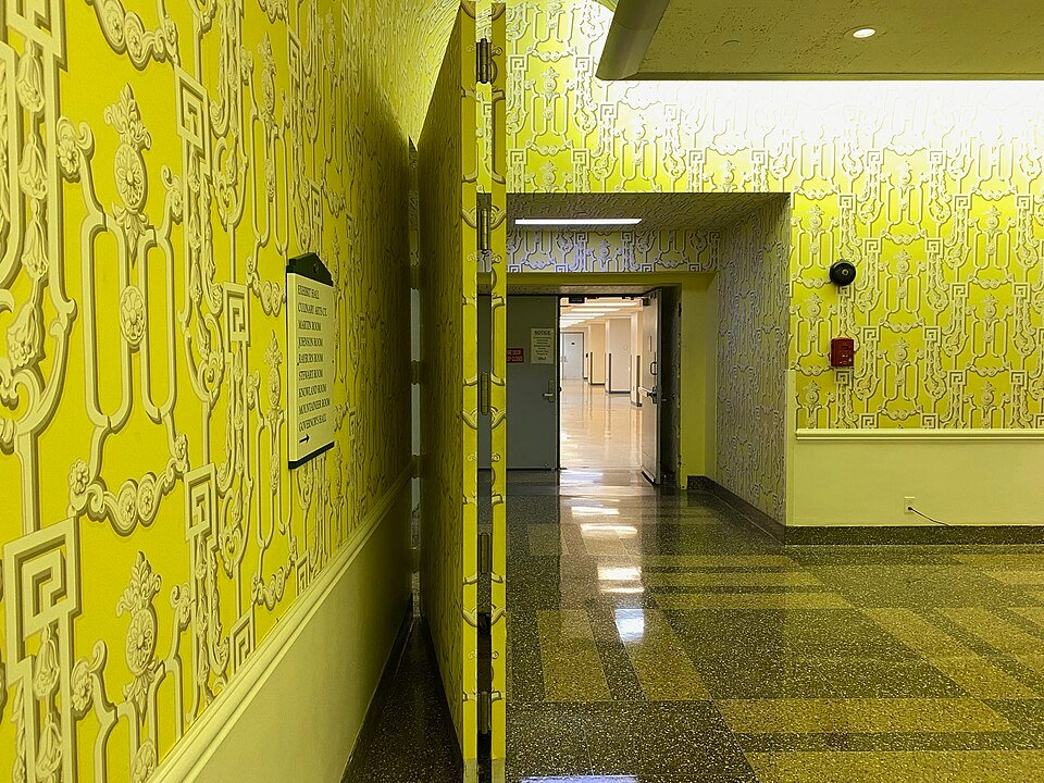 A hinged false wall covered in the same wallpaper, opening onto a corridor of the Greenbrier Bunker