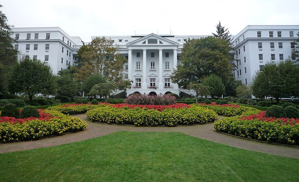 The white Greenbrier resort building seen across a formal flower garden