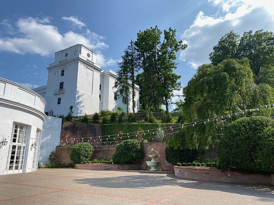 The white tower of the West Virginia Wing on a hill above a terrace at the Greenbrier resort